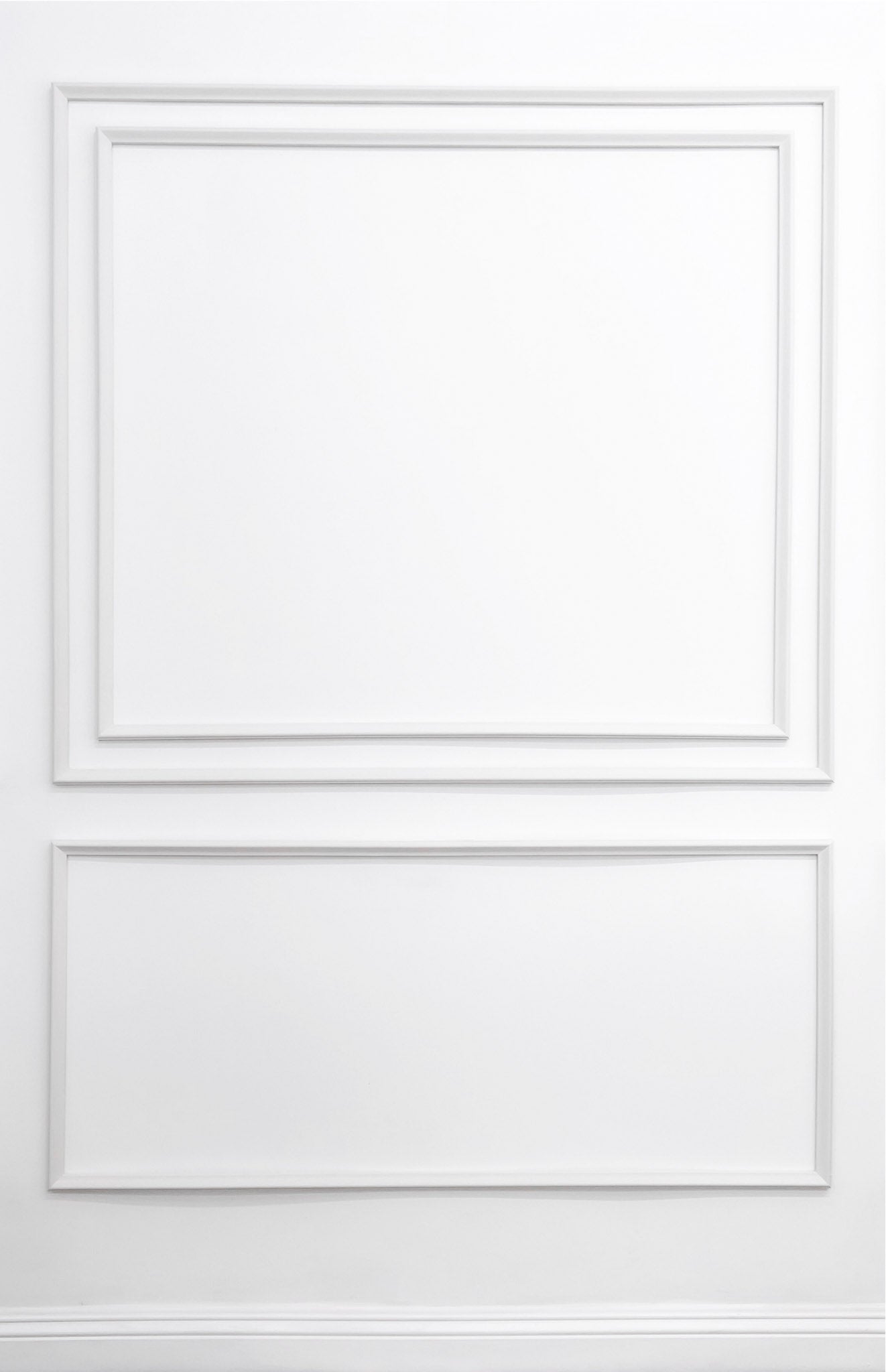 Removable and reusable self-adhering wall moulding kit featuring layered double-panel design with nested inner frame, handcrafted from real wood in the USA. Renter-friendly with complimentary replacement adhesive.