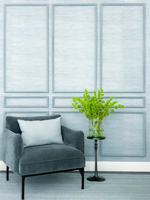 Classic nine piece Poplar wall moulding kit finished in milk paint, installed over wallpaper in a styled living room — handcrafted real wood by Luxe Architectural