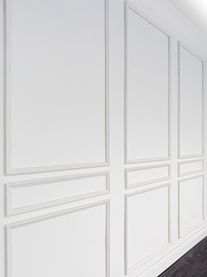 Side view of feature wall transformed with the Removable & Reusable Classic Nine Piece Wall Moulding Kit, adding a balanced panel design using fully assembled premium wood mouldings.