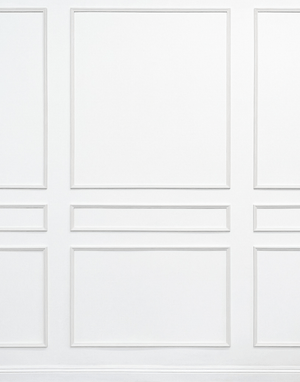 Close-up of classic three-panel wall moulding layout showing middle rail detail and real wood craftsmanship.